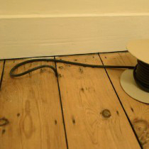 DraughtEx on a roll being fitted into a wooden floor