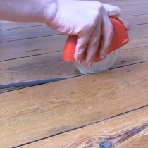 Draughtex being fitted into a flooerboard gap using the applicator