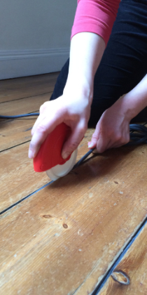 Draughtex being fitted into a flooerboard gap using the applicator