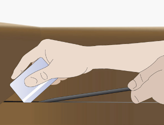 A hand using an old credit to insert the first 1-2 inches of DraughtEx
