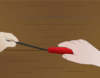 A hand using the applicator to insert DraughtEx into the gap