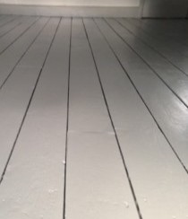 A wooden floor with DraughtEx fitted between the gaps