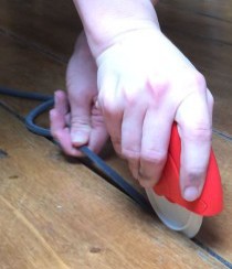 Draughtex being fitted into a flooerboard gap using the applicator