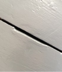A wooden floor without DraughtEx fitted between the gaps