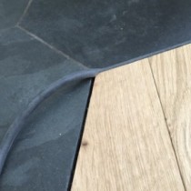 A wooden floor without DraughtEx fitted between the gaps