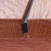 Close up of how DraughtEx seals gaps between floor boards