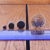 Different sizes of DraughtEx placed next to a ruler and coin for comparison